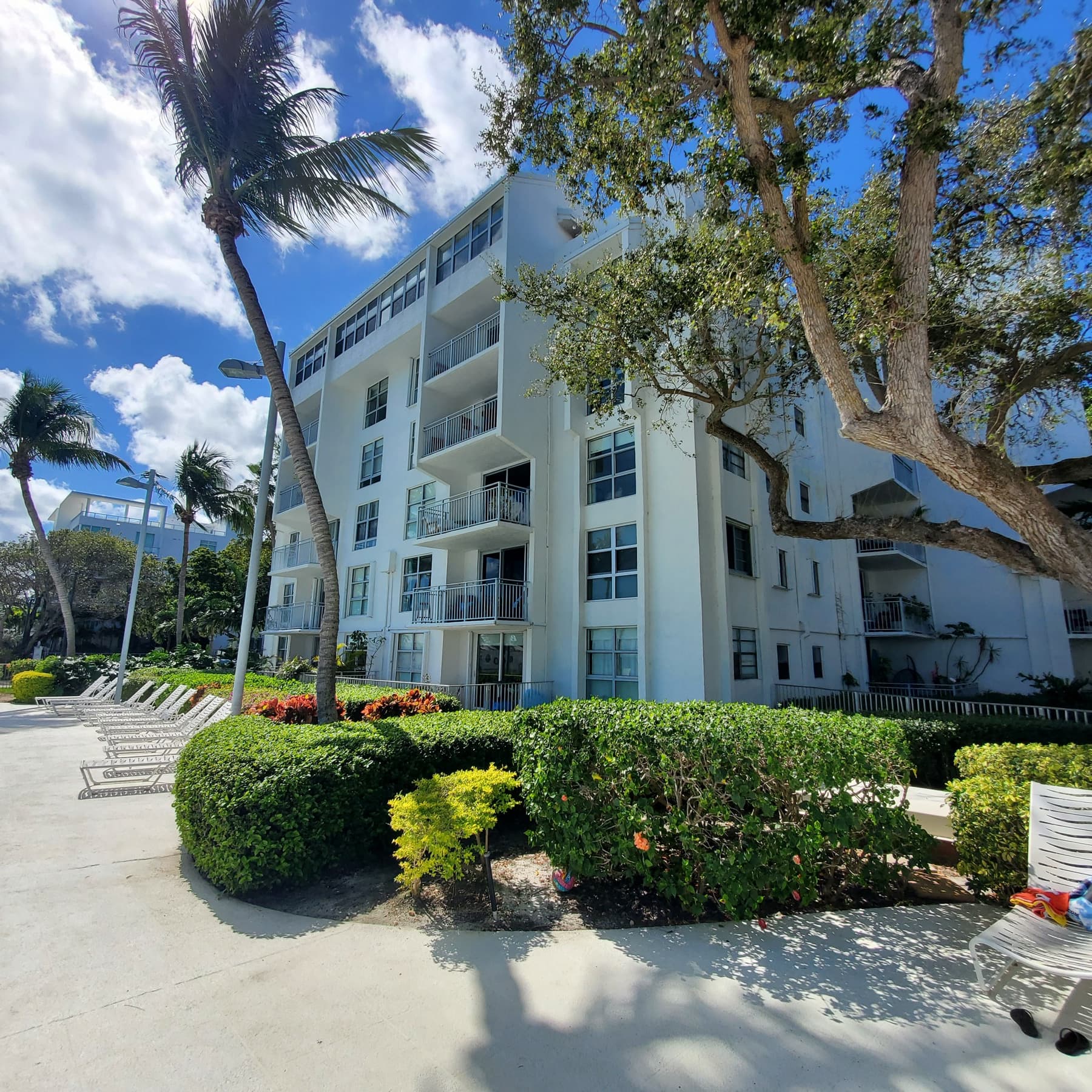 Six-story residential building with landscaped grounds